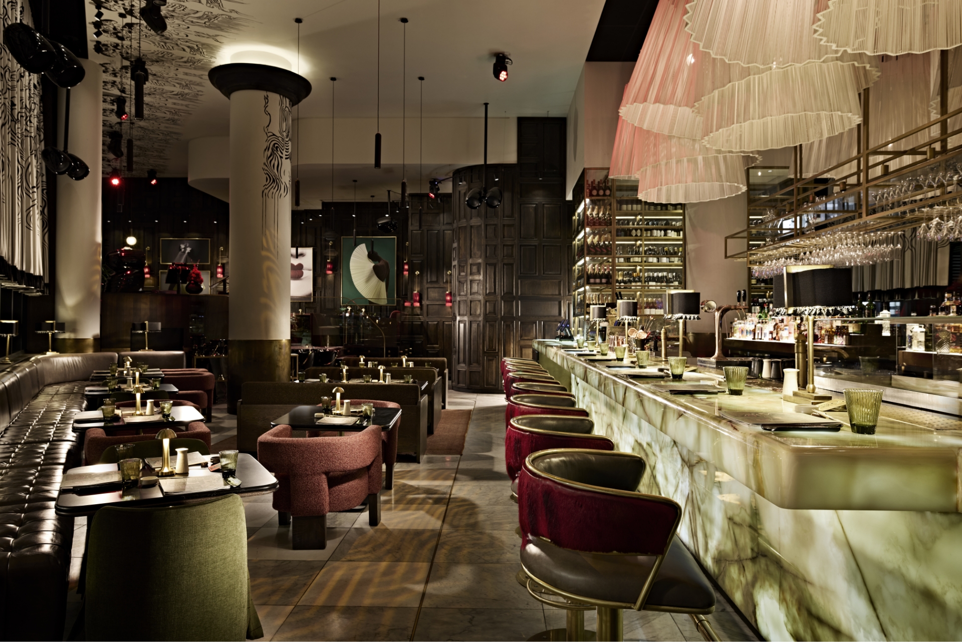 Sophisticated Sandton event venue with marble counter, velvet seating, decorative columns, and ambient lighting creating an upscale elegant interior dining atmosphere